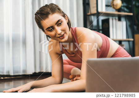 Flexible and dexterity woman in sportswear doing reverse gaiety yoga position 121798985