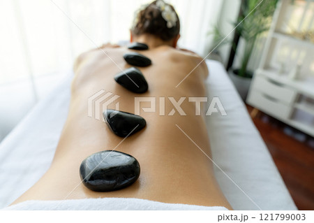 Hot stone massage at spa salon in luxury resort. Quiescent 121799003