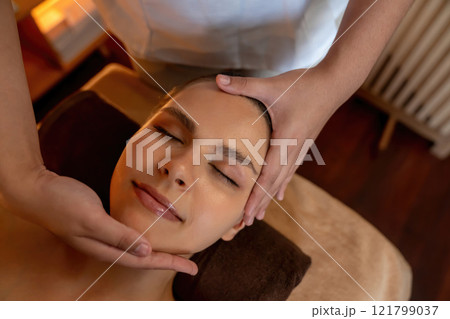 Caucasian woman enjoying relaxing anti-stress head massage. Quiescent Caucasian woman enjoying relaxing anti-stress head massage. Quiescent 121799037