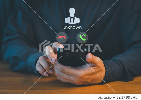 Concept of scam, fraud with a phone from the scammer. Person answering the incoming call. Phone call was from an unknown number. Call center gang or stranger. Hoax person with a fake identity. 121799545