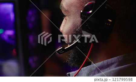 Close up of pro streamer streaming videogame on powerful computer during online gaming championship, talking into headset. Gamer taking part in Esport team of gamers, competing in game, camera A Close up of pro streamer streaming videogame on powerful computer during online gaming championship, talking into headset. Gamer taking part in Esport team of gamers, competing in game, camera A 121799598
