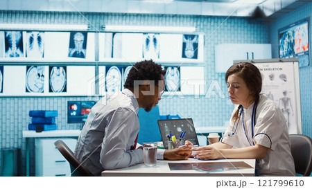 Healthcare professional uses an oximeter to measure the oxygen levels for patient at check up, diagnostic tools for accurate medical advice. Monitoring pulse and saturation with indicator. Camera B. Healthcare professional uses an oximeter to measure the oxygen levels for patient at check up, diagnostic tools for accurate medical advice. Monitoring pulse and saturation with indicator. Camera B. 121799610