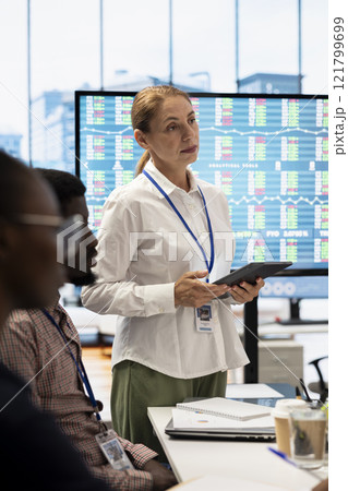 General manager and investors gathering for an investment fair meeting, discussing potential growth opportunities. Business staff reviewing financial projections and strategic initiatives. General manager and investors gathering for an investment fair meeting, discussing potential growth opportunities. Business staff reviewing financial projections and strategic initiatives. 121799699
