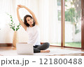 woman stretching  in living room at her house 121800488