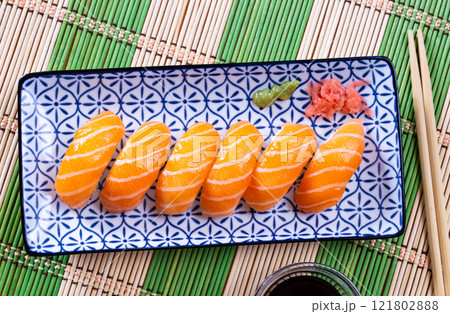 Sushi sake nigiri with salmon served on platter Sushi sake nigiri with salmon served on platter 121802888