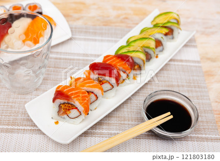 For several guests, Japanese lunch is served - set of uramaki rolls, soy sauce, For several guests, Japanese lunch is served - set of uramaki rolls, soy sauce, 121803180
