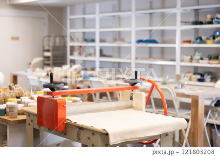 Polymer clay rolling machine in ceramic workshop Polymer clay rolling machine in ceramic workshop 121803208