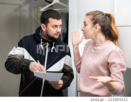 Man and woman discussing troubles with rent payment 121803212