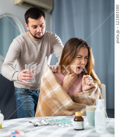 Sick woman resting at home with husband 121803380