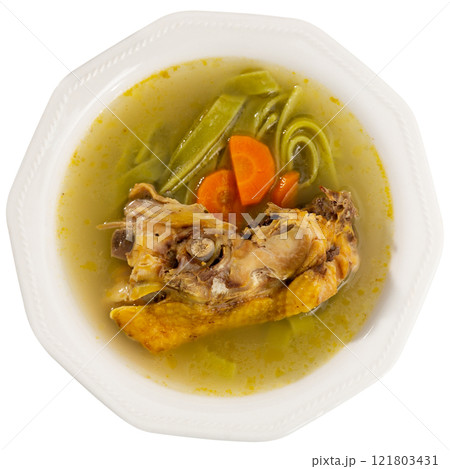Soup made from fragrant chicken broth, potato slices, pasta and carrots. 121803431
