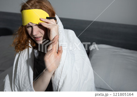 Young woman is struggling with sleep in her cozy, inviting bedroom, surrounded by comfort Young woman is struggling with sleep in her cozy, inviting bedroom, surrounded by comfort 121805164