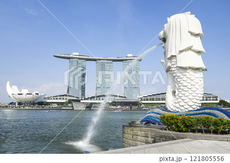 Low-angle view of the Merlion with the background of Marina Bay Sands buildings in Singapore. Merlion is the official mascot of Singapore. Low-angle view of the Merlion with the background of Marina Bay Sands buildings in Singapore. Merlion is the official mascot of Singapore. 121805556