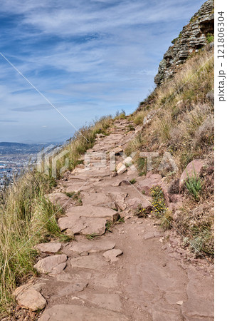 Trail on Table Mountain with vibrant, beautiful nature along a path. Trees and lush green bushes growing in harmony. Peaceful soothing fresh air with stunning views of natural landscape Trail on Table Mountain with vibrant, beautiful nature along a path. Trees and lush green bushes growing in harmony. Peaceful soothing fresh air with stunning views of natural landscape 121806304