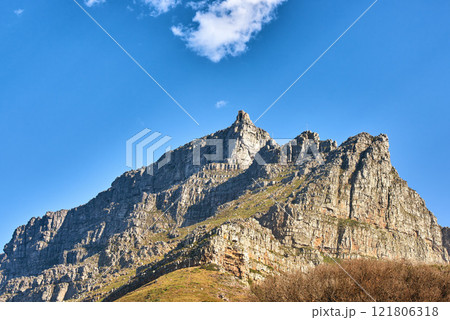 Beautiful landscape of Table Mountain below with blue sky and copy space. Peaceful and scenic view of a peak with large rocks and grass. A summit in nature ideal for adventure walks and hiking trips Beautiful landscape of Table Mountain below with blue sky and copy space. Peaceful and scenic view of a peak with large rocks and grass. A summit in nature ideal for adventure walks and hiking trips 121806318