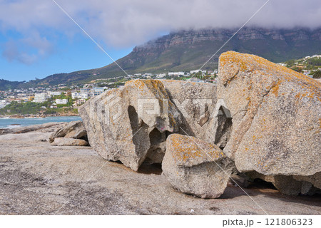 Boulders on the rocky coast of Western Cape, South Africa, Landscape view of a beautiful mountain and seashore in Cape Town. Natural seaside environment in a popular tourist location for a holiday Boulders on the rocky coast of Western Cape, South Africa, Landscape view of a beautiful mountain and seashore in Cape Town. Natural seaside environment in a popular tourist location for a holiday 121806323