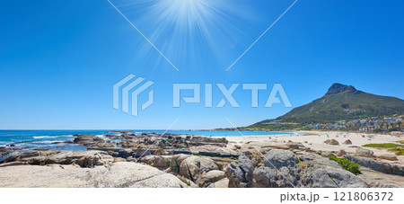 Panorama of a rocky beach near the ocean and mountain on a sunny day in South Africa. Landscape wallpaper of a coastline with Lions head against blue horizon with sun flare and copy space in summer Panorama of a rocky beach near the ocean and mountain on a sunny day in South Africa. Landscape wallpaper of a coastline with Lions head against blue horizon with sun flare and copy space in summer 121806372