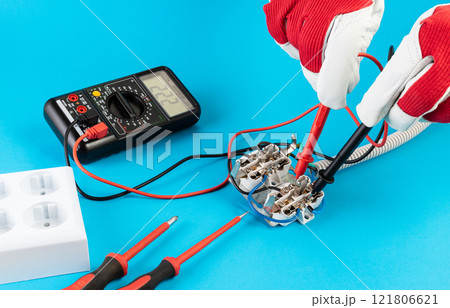 measuring voltage with a multimeter at the contacts of an electrical outlet measuring voltage with a multimeter at the contacts of an electrical outlet 121806621