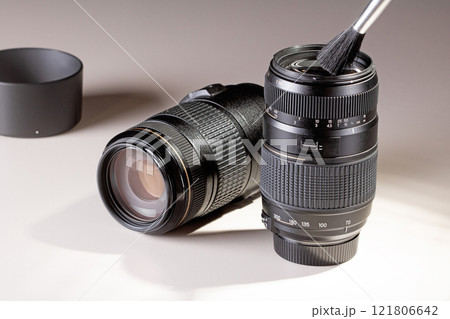 Cleaning dust from a lens for a SLR camera with a brush Cleaning dust from a lens for a SLR camera with a brush 121806642