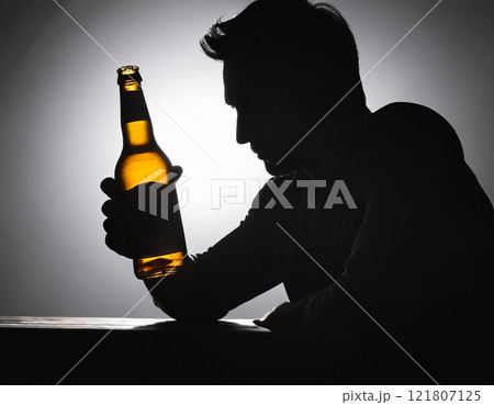 silhouette of a man alcohol addiction concept 121807125