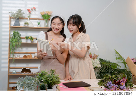 Gardeners florist at her own floral shop taking care of flowers. 121807884