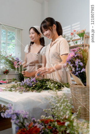 Gardeners florist at her own floral shop taking care of flowers. 121807985