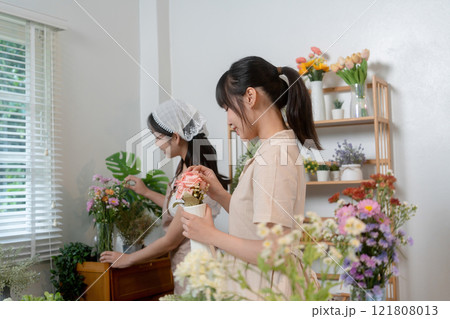 Gardeners florist at her own floral shop taking care of flowers. 121808013