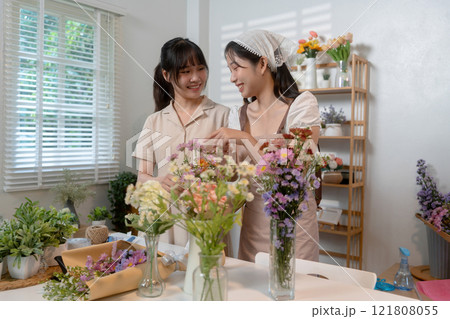 Gardeners florist at her own floral shop taking care of flowers. 121808055