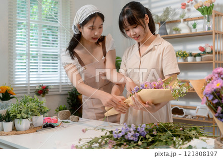 Gardeners florist at her own floral shop taking care of flowers. Gardeners florist at her own floral shop taking care of flowers. 121808197