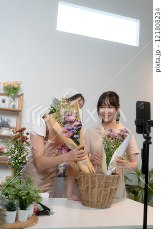 Gardeners florist at her own floral shop taking care of flowers. Gardeners florist at her own floral shop taking care of flowers. 121808234