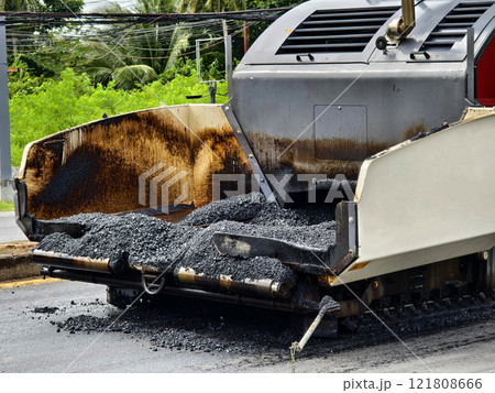 Asphalt paving machine laying down asphalt 121808666