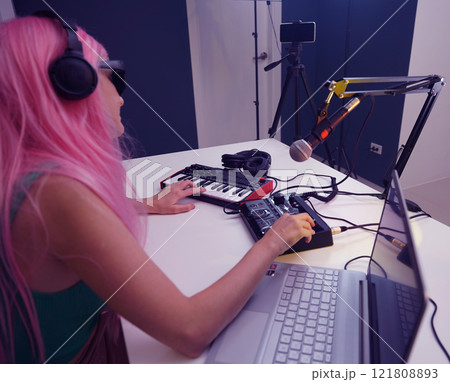 Beautiful young singer and musician broadcast from her home studio 121808893