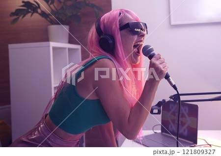 Beautiful young singer and musician broadcast from her home studio Beautiful young singer and musician broadcast from her home studio 121809327