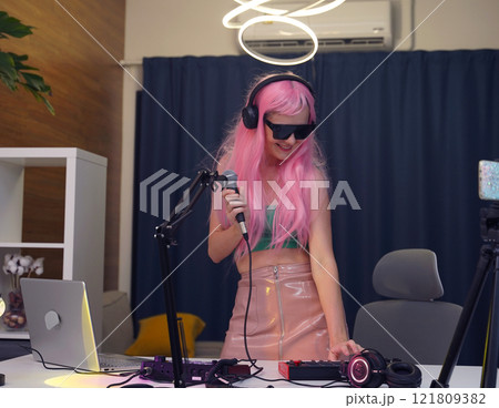 Beautiful young singer and musician broadcast from her home studio 121809382