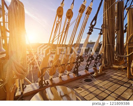 Ropes stretched across the masts of an old ship 121809386