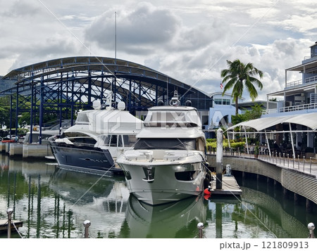 A tranquil and serene marina scene featuring various boats A tranquil and serene marina scene featuring various boats 121809913