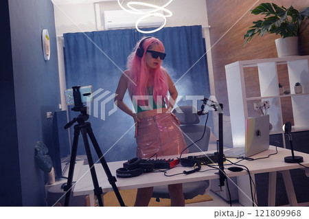 Beautiful young singer and musician broadcast from her home studio 121809968