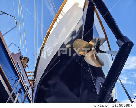 A lifeboat is securely tied to the mast of a sailing vessel 121809997