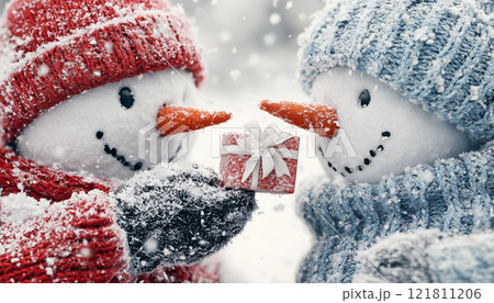 Two Cheerful Snowmen Sharing a Gift in a Magical Winter Scene 121811206