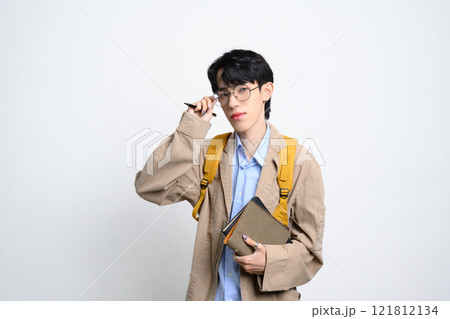 Portrait of college student with glasses holding books on white background. Educational and back to school concept Portrait of college student with glasses holding books on white background. Educational and back to school concept 121812134