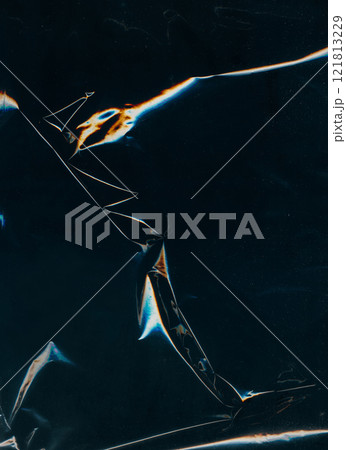 Distressed foil overlay. Creased film. Scratched glass texture. Blue orange color glitch light flares dust particles wrinkled rough filter dark black illustration art abstract background. 121813229