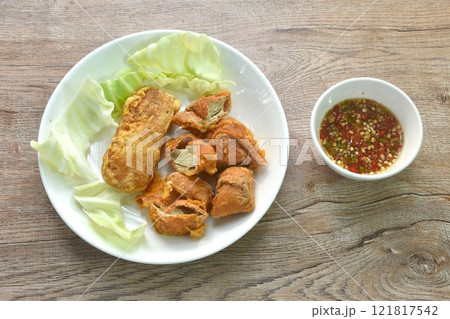 fried slice Vietnamese chicken sausage recipe with cabbage on plate dipping spicy sauce fried slice Vietnamese chicken sausage recipe with cabbage on plate dipping spicy sauce 121817542