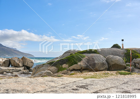 Copy space, sea and ocean rocks on a remote, quiet and serene beach in a relaxing tropical coastal destination with a mountain background. Seascape, blue sky and tidal water on secluded island abroad Copy space, sea and ocean rocks on a remote, quiet and serene beach in a relaxing tropical coastal destination with a mountain background. Seascape, blue sky and tidal water on secluded island abroad 121818995