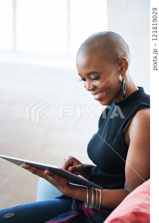 Bald african american woman using digital tablet computer at home 121819029