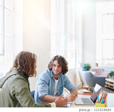 College students working together two young men brainstorming ideas for project sitting at desk using laptop computer in class 121819084
