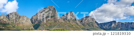 Twelve Apostles at Table Mountain in Cape Town against a blue sky background from below. Breathtaking view of plants and shrubs growing around a majestic rocky valley and scenic landmark in nature Twelve Apostles at Table Mountain in Cape Town against a blue sky background from below. Breathtaking view of plants and shrubs growing around a majestic rocky valley and scenic landmark in nature 121819310