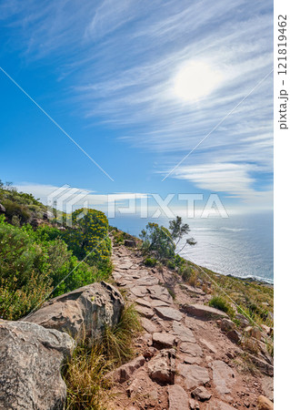Lions Head Mountain trail with a relaxing beautiful ocean view. Lush green trees and bushes growing in harmony with nature. Popular attraction for tourists who enjoy outdoor adventure 121819462
