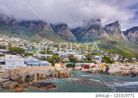 Landscape view of a seaside town along the mountain on a cloudy day in Cape Town, South Africa. Scenic view of a quiet and secluded residential area on the coast for tourists and holidays in summer Landscape view of a seaside town along the mountain on a cloudy day in Cape Town, South Africa. Scenic view of a quiet and secluded residential area on the coast for tourists and holidays in summer 121819771