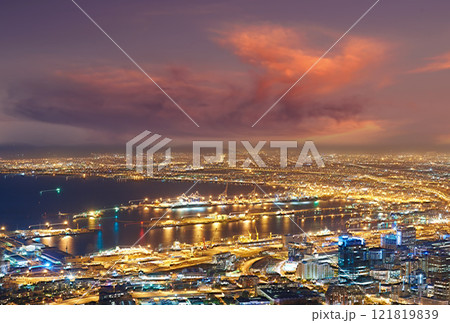 Scenic view of Cape Town at night from Signal Hill in South Africa. Beautiful landscape view of the city lights and buildings against a dark and cloudy evening sky. Popular tourist town at twilight 121819839