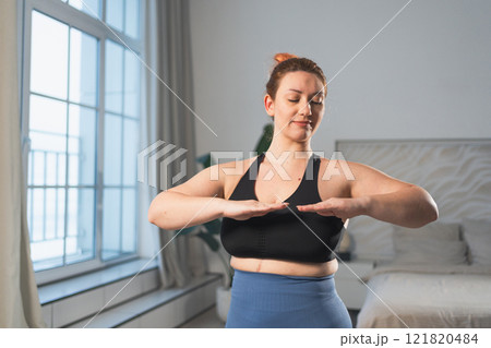 Fitness workout training. Woman practicing fitness at home. Plus size female doing sports exercise at home indoor. Girl in sportswear have workout weight training for weight loss. Sport and fitness 121820484