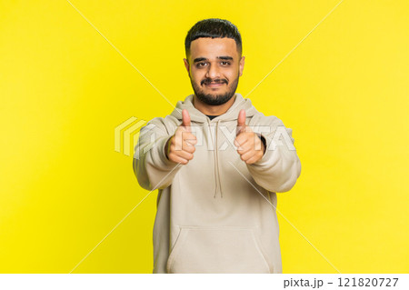 Indian man raises thumbs up agrees or gives positive reply recommends advertisement likes good idea 121820727
